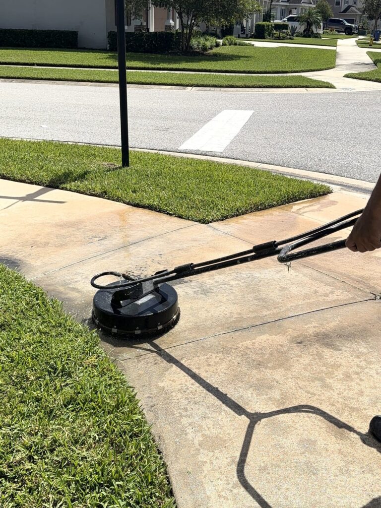 Surface cleaner lifting dirt off a neighborhood sidewalk
