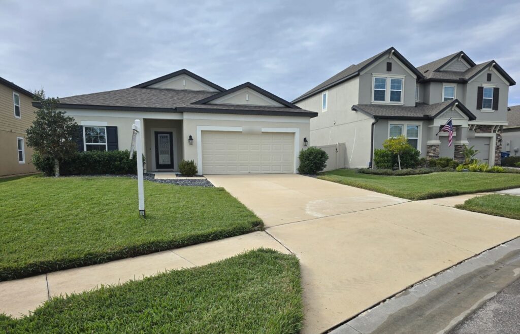 Clean concrete driveway and walkway after pressure washing by Aqua Blast